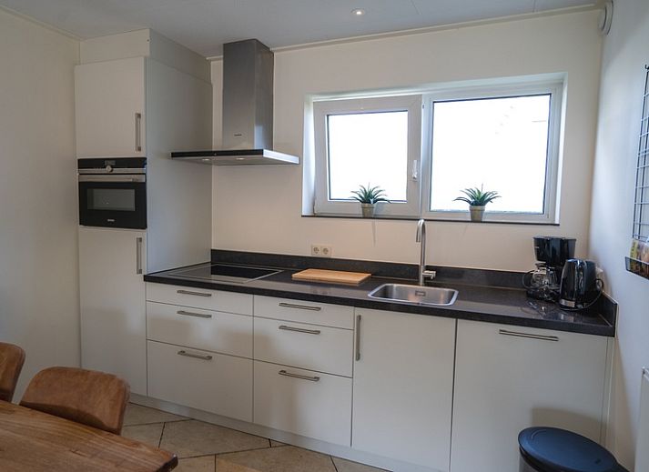 Cozy living room in Holiday Home 't Hoogelandt 134, De Dennen, Texel with comfortable sofas.