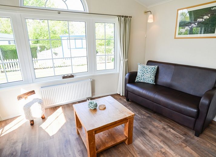 Cozy living room in Holiday Park De Koorn-aar Type F, Texel, with comfortable sitting area and dining area.