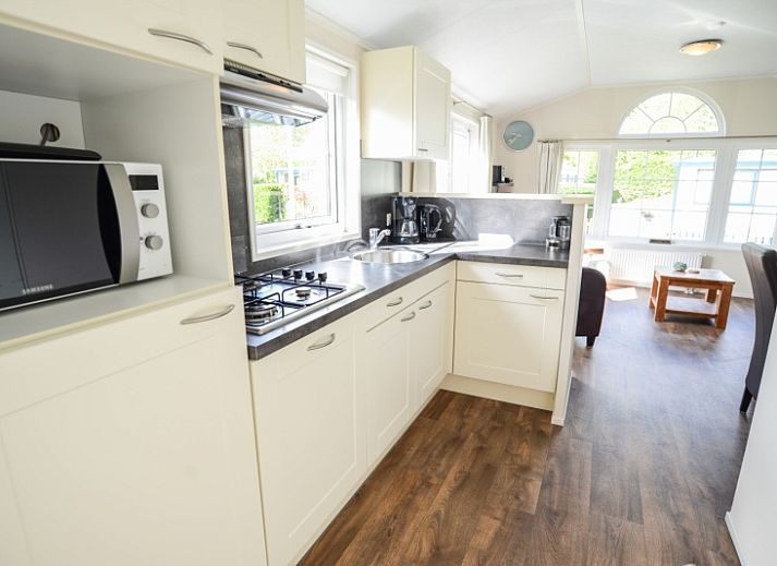 Cozy living room in Holiday Park De Koorn-aar Type F, Texel, with comfortable sitting area and dining area.