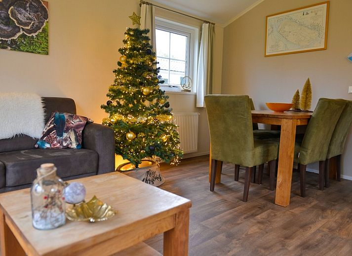 Cozy living room in Holiday Park De Koorn-aar Type F, Texel, with comfortable sitting area and dining area.