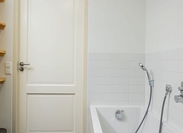 Cozy bedroom in Apartment Bath Douche, Oosterend, with wooden headboard and star painting.