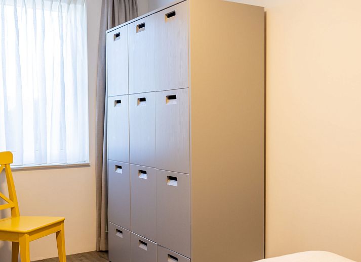 Cozy bedroom in Apartment Bath Douche, Oosterend, with wooden headboard and star painting.