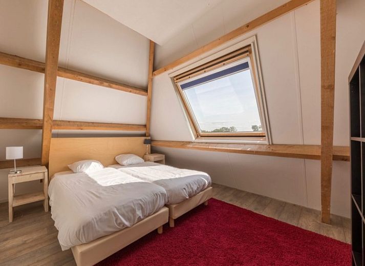 Modern sitting area in Tree Lodge, Ballum, Ameland with spacious sofas and television.