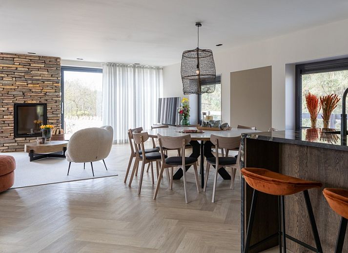 Rieten dak van vakantiehuis MIEKIE in Buren, Ameland, omgeven door gras en bomen.