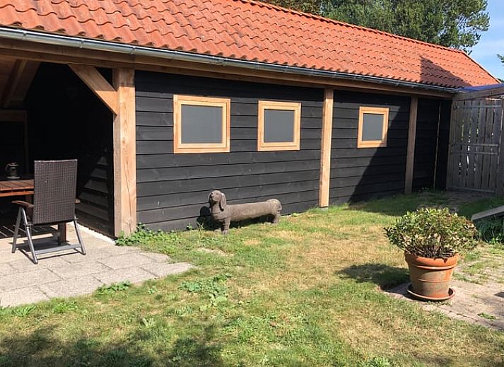 Cozy dining area in Holiday home in Buren Ameland with wooden interior.
