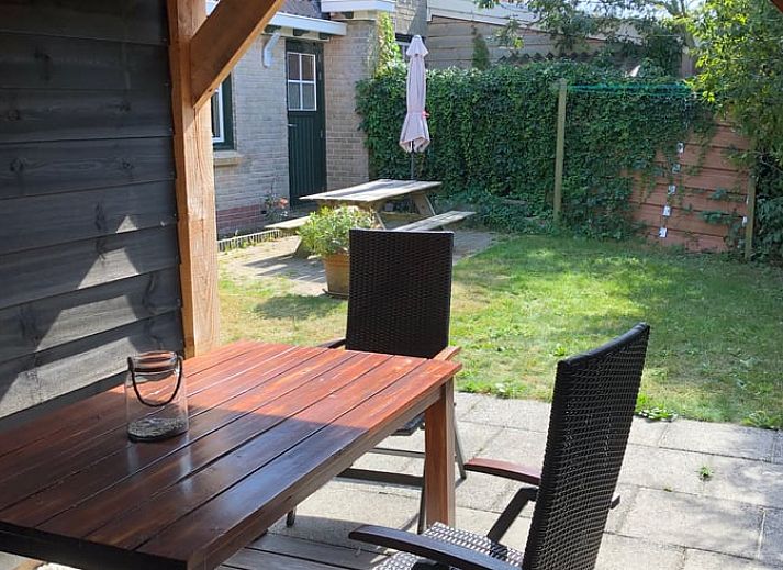 Cozy dining area in Holiday home in Buren Ameland with wooden interior.