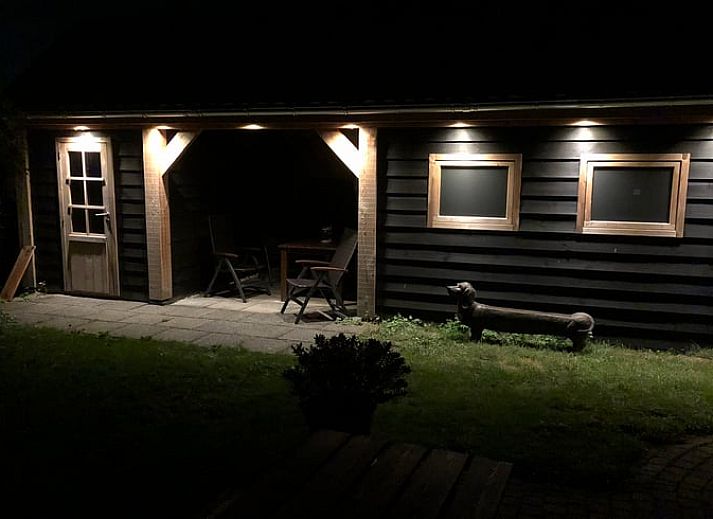 Cozy dining area in Holiday home in Buren Ameland with wooden interior.
