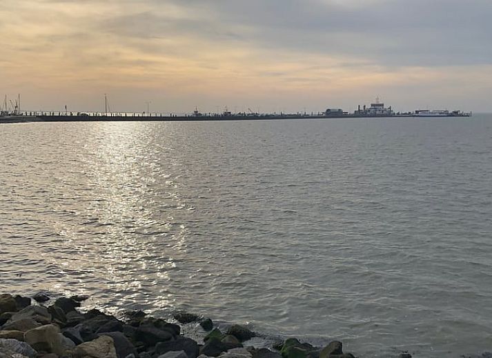Comfortable living room with open kitchen in Holiday home in Buren Ameland.
