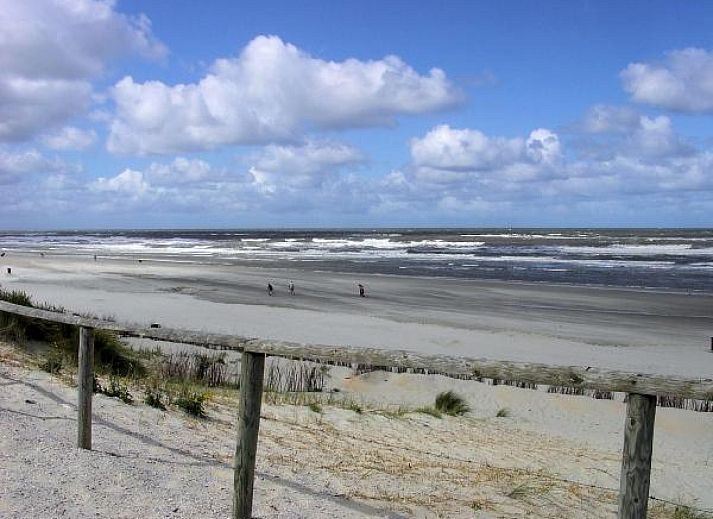 Iconic lighthouse near vacation home WA003 in Buren, Ameland, surrounded by dunes.