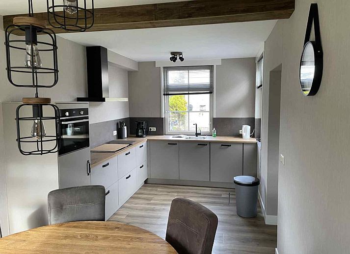 Iconic lighthouse near vacation home WA003 in Buren, Ameland, surrounded by dunes.