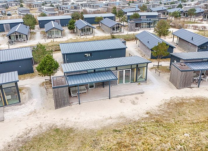 Detached house in Hollum, Ameland with modern veranda and glass facades, ideal for vacations on the Wadden Islands.