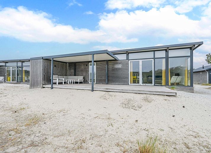 Detached house in Hollum, Ameland with modern veranda and glass facades, ideal for vacations on the Wadden Islands.