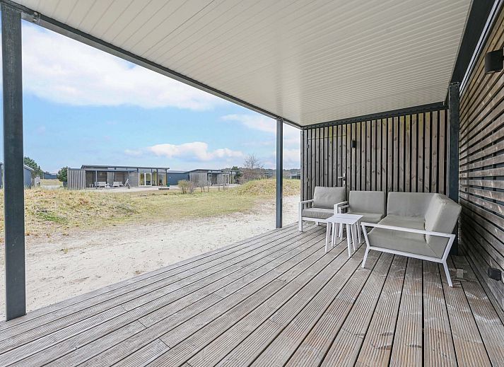 Detached house in Hollum, Ameland with modern veranda and glass facades, ideal for vacations on the Wadden Islands.