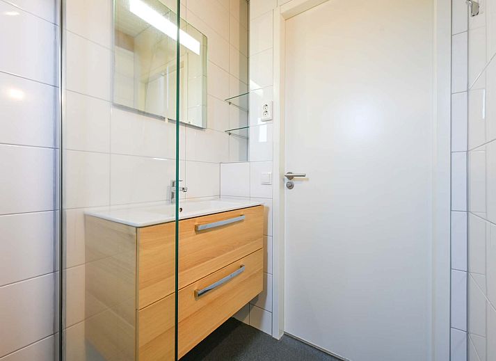 Cozy sitting area on the veranda of Detached house in Hollum, Ameland, perfect for relaxation on the Wadden Islands.