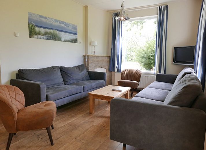 The Woonhuis vacation home in Hollum, Ameland with classic brick facade and green surroundings.