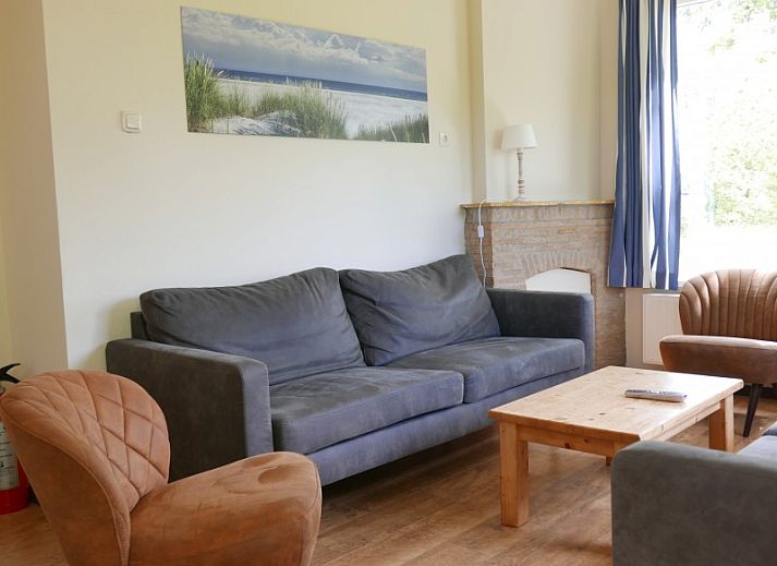 The Woonhuis vacation home in Hollum, Ameland with classic brick facade and green surroundings.