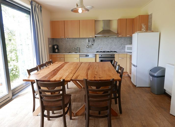 The Woonhuis vacation home in Hollum, Ameland with classic brick facade and green surroundings.