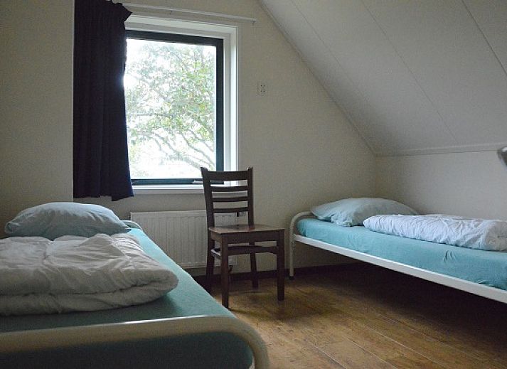 Cozy living room in Het Woonhuis, vacation home in Hollum, Ameland with comfortable sofas and lots of light.