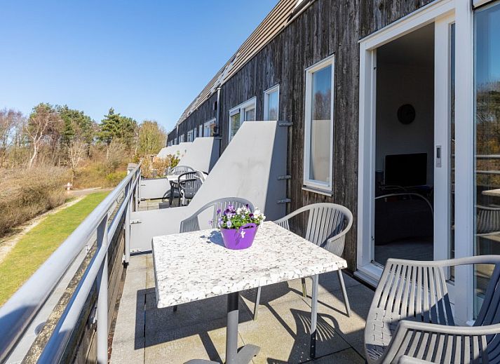 Stilvolles Wohnzimmer mit TV und Buecherregal in Amelander Kaap 126, Hollum, Ameland.