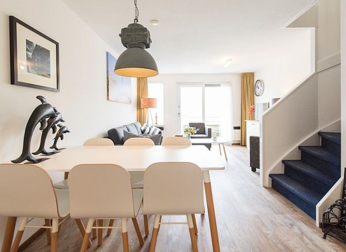 Gezellige woonkamer in appartement Zilverschoon, Hollum, Ameland met comfortabele zitruimte en uitzicht op terras.