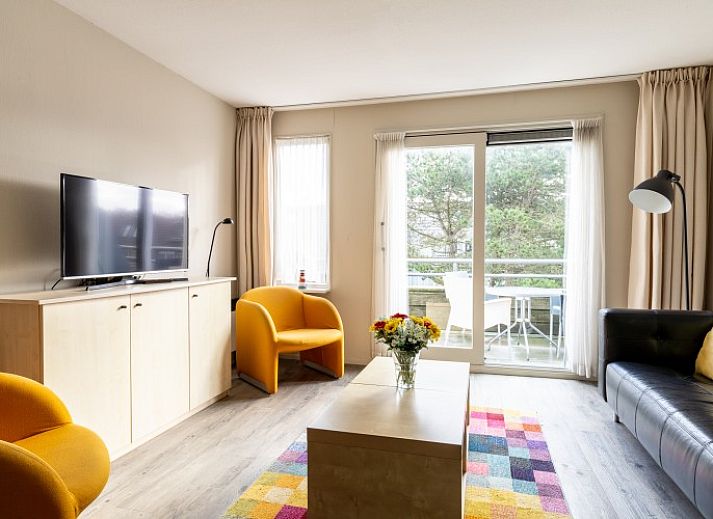 Cozy living room in Bornrif apartment, Hollum, Ameland overlooking the terrace.