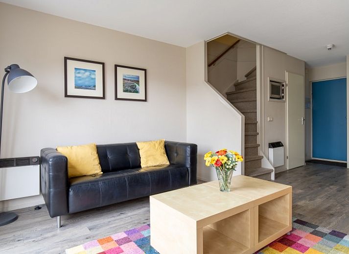 Cozy living room in Bornrif apartment, Hollum, Ameland overlooking the terrace.