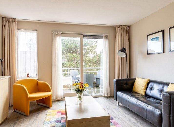 Cozy living room in Bornrif apartment, Hollum, Ameland overlooking the terrace.