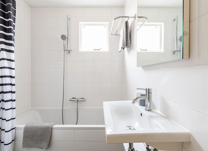 Bright living space in Bornrif vacation apartment, Hollum, Ameland with modern furnishings.