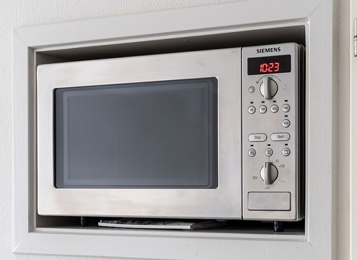 Bright living space in Bornrif vacation apartment, Hollum, Ameland with modern furnishings.