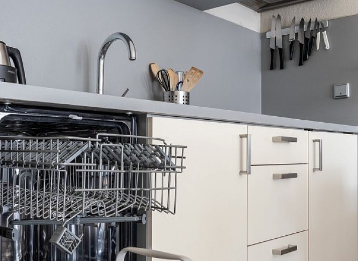 Stylish sitting area in Bornrif, Hollum, Ameland with comfortable sofa and colorful rug.