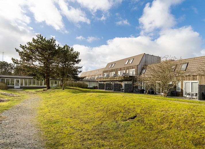 Stylish sitting area in Bornrif, Hollum, Ameland with comfortable sofa and colorful rug.