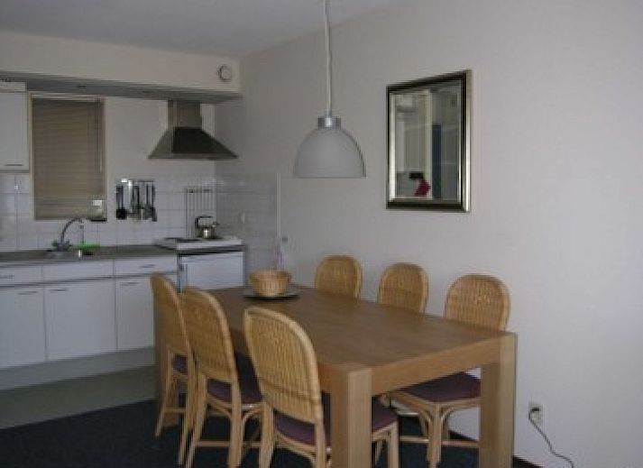 Gemtliches Wohnzimmer in Amelander Kaap Nr. 54, Hollum, Ameland mit rotem Sofa und moderner Einrichtung.