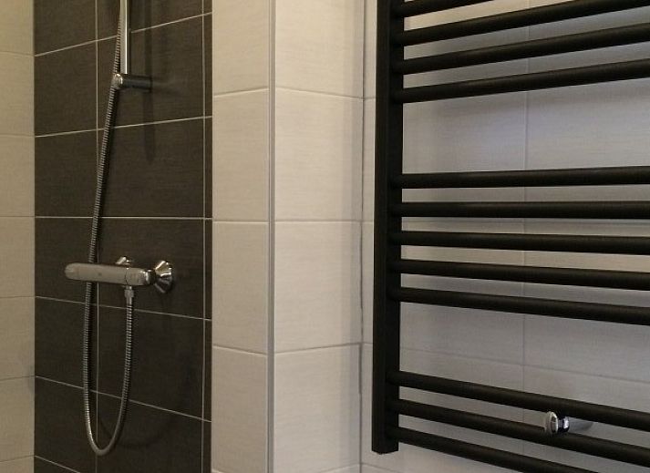 Stylish living room of Louwtjesduin Oost vacation home in Schiermonnikoog overlooking the green garden, Wadden Islands.