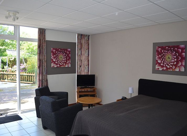 Aussenansicht von Boersma's Apartments auf Schiermonnikoog, Ferienhaus mit moderner Veranda und Blumenkaesten.