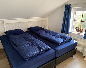 Zolderkamer in La Guitarra vakantiehuis De Cocksdorp Texel met comfortabele bedden.