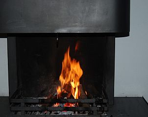 Knusse open haard in De Krim 641 vakantiehuis, De Cocksdorp Texel voor gezellige avonden.