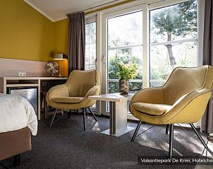 Cozy sitting area in Luxury 2 person Hotel Chalet on Texel, overlooking the green surroundings of De Cocksdorp.