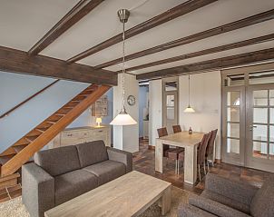 Dining area and stairs in Type T-3 vacation home, De Cocksdorp, Texel, with wooden elements.
