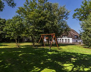 Green surroundings with playground at Type T-3 vacation home, De Cocksdorp, Texel.