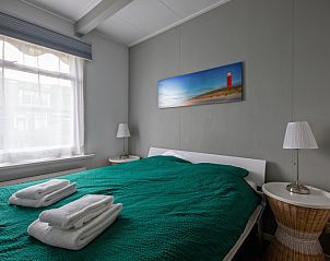 Comfortabele slaapkamer in Kikkertstraat 065, vakantiehuis De Cocksdorp Texel met knus bed en natuurlijke verlichting.