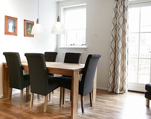 Dining area with wooden table in Type 8 - 2108 vacation home, Texel.