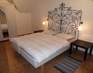 Bedroom with ornate bed frame in Type 8 - 2108 vacation home, Texel.