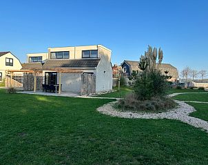 Spacious garden of Holiday home 30A in De Cocksdorp, Texel with green surroundings.