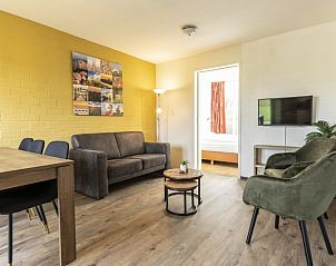 Stylish sitting area in Holiday home 30A, De Cocksdorp, Texel with comfortable sofa.