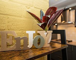 Decorative details in Holiday home 30A, De Cocksdorp, Texel with 'Enjoy' sign.