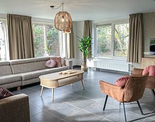 Cozy sitting area in Holiday Home De Vuurtoren, Texel with lots of natural light.