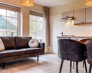 Cozy living room in Holiday home Hogezandskil, De Cocksdorp, Texel with comfortable seating area and lots of light.