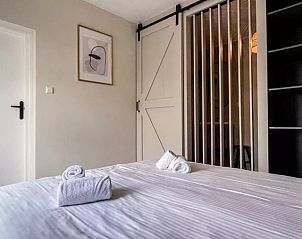 Stylish bedroom with sliding door in Holiday Home Hogezandskil, De Cocksdorp, Texel for extra privacy.