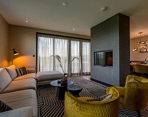 Stylish living room in 6 person vacation home in De Cocksdorp Texel with comfortable seating area.