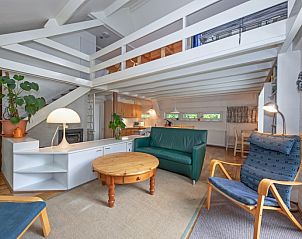 Spacious living room of Holiday home Slufterduin 108 in De Cocksdorp Texel, with modern furnishings and lots of natural light.
